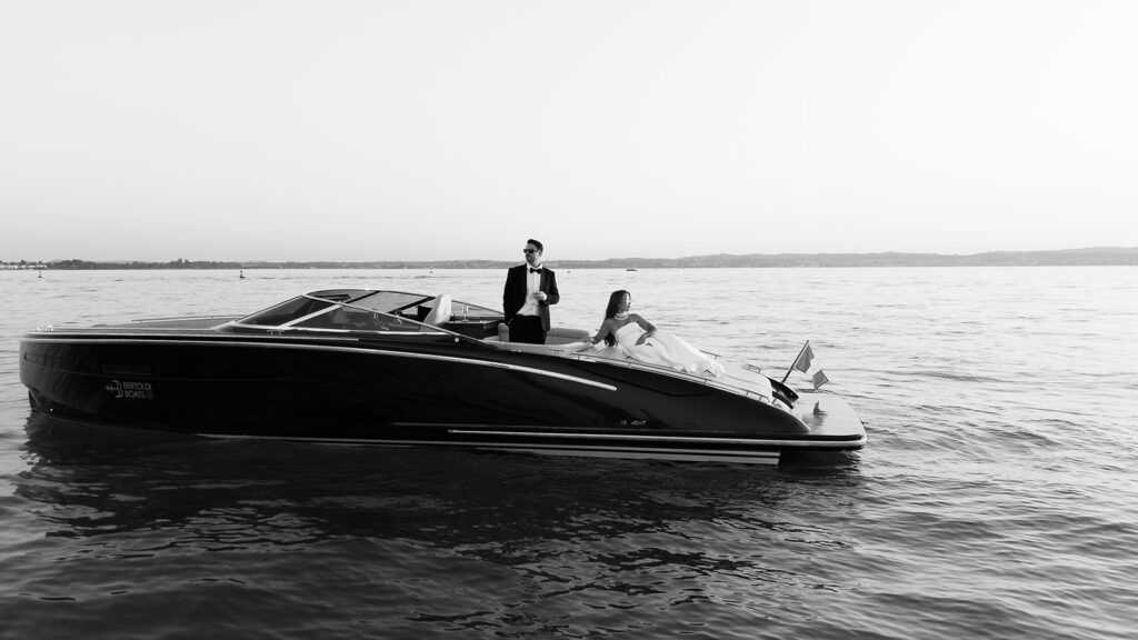 Couple on a wooden boat during their Lake Garda destination wedding