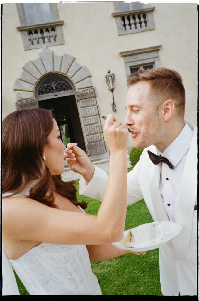 Couple celebrating with cake at their Isola del Garda elopement wedding in Italy.
