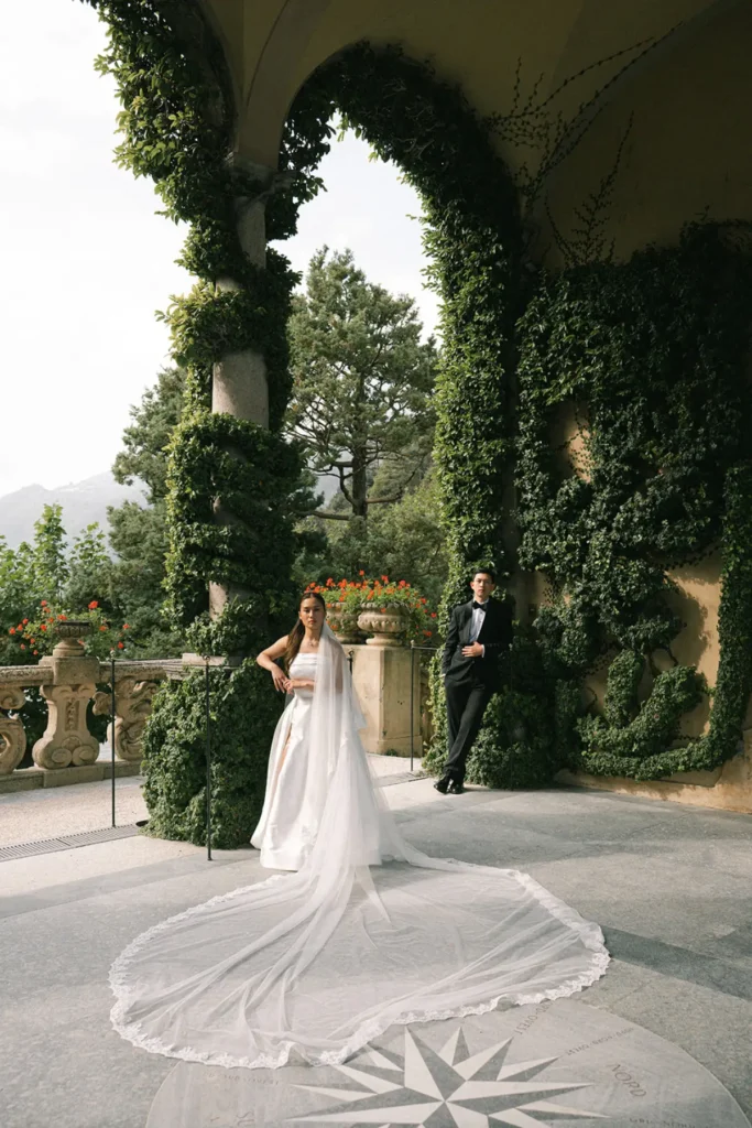 Bride with long veil and train at Villa del Balbianello terrace, elegant Lake Como wedding photography.