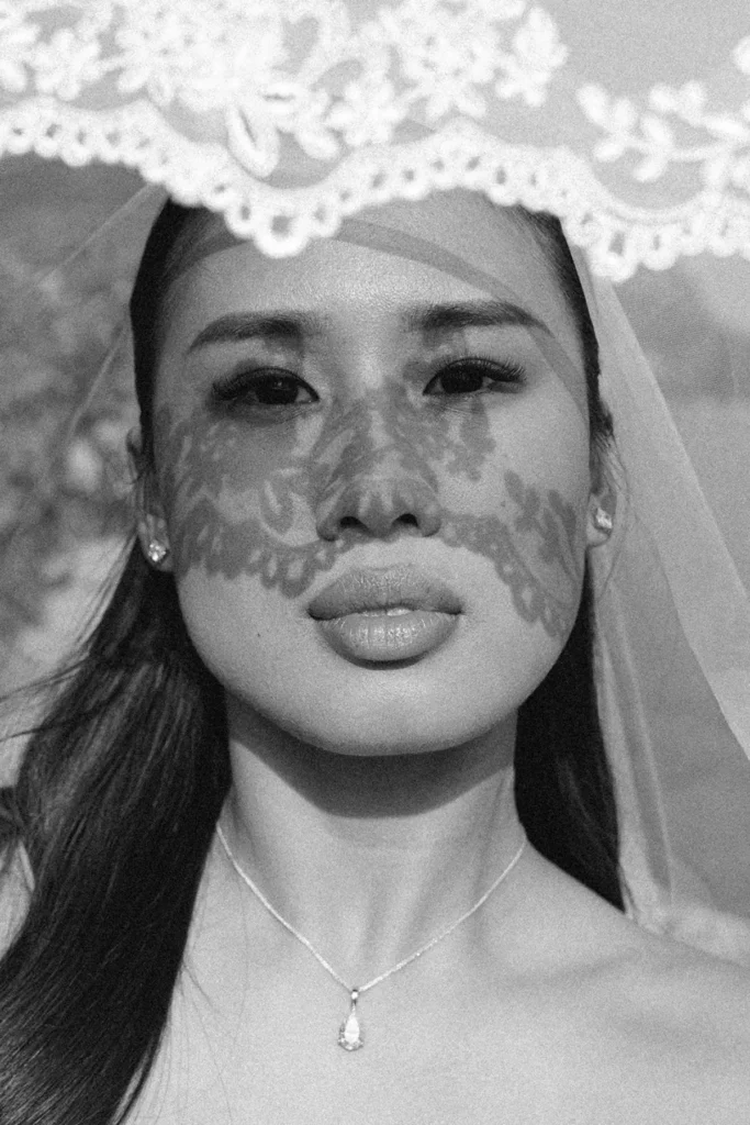 Black-and-white bridal close-up with lace veil shadow, timeless film photography for Lake Como weddings.