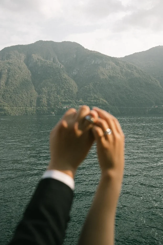 Wedding rings detail shot with Lake Como in the background, Villa del Balbianello elopement story