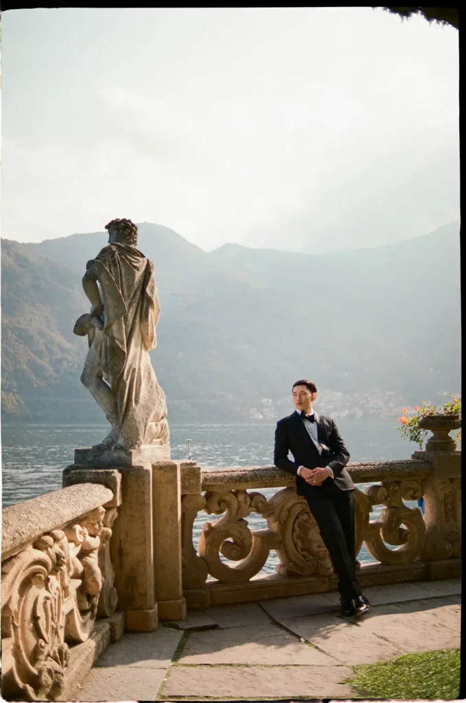 Groom portrait at Villa del Balbianello balcony overlooking Lake Como, destination wedding photographer style.