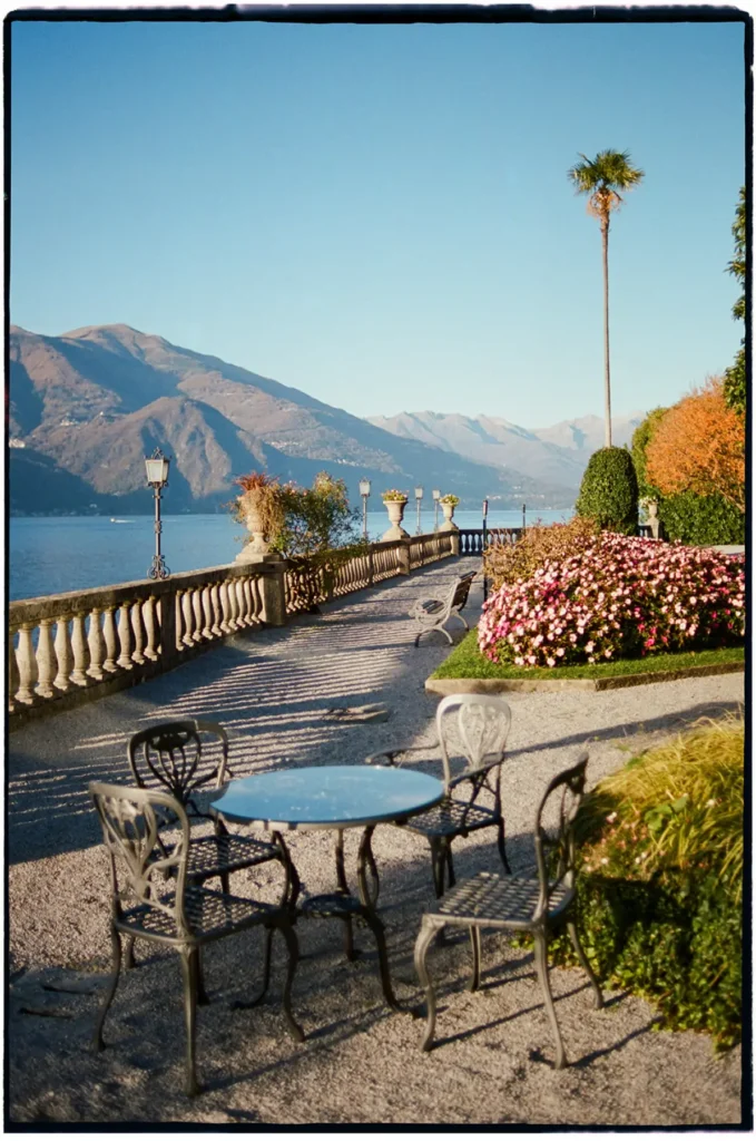 Lake Como terrace at Grand Hotel Villa Serbelloni in Bellagio with mountains and morning-blue sky