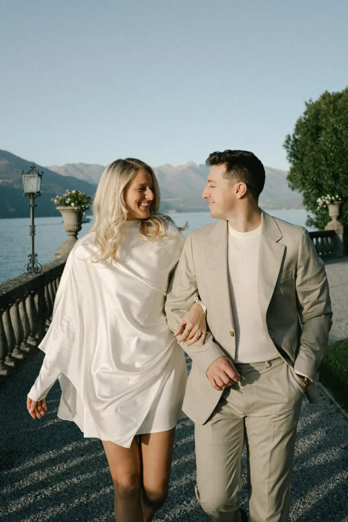 Couple walking together at Villa Serbelloni Bellagio overlooking Lake Como in golden light