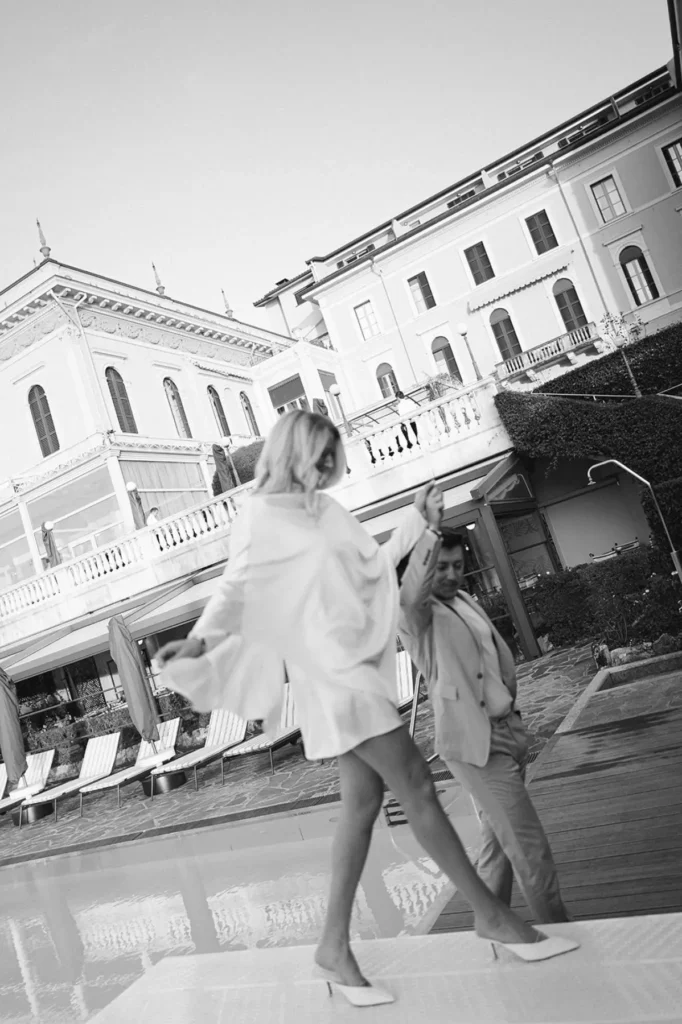 Couple walking by the pool at Grand Hotel Villa Serbelloni Bellagio, cinematic black-and-white moment