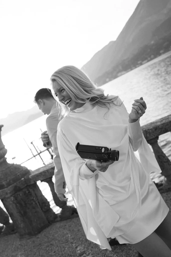 Bride-to-be holding a Super 8 camera by Lake Como at Villa Serbelloni Bellagio, black-and-white portrait