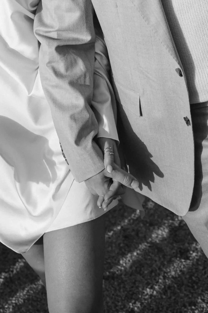 Close-up of couple holding hands, elegant outfit details at Grand Hotel Villa Serbelloni Bellagio, black-and-white