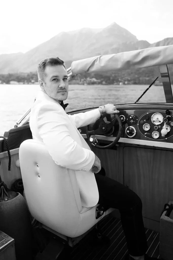 Groom on a classic Lake Como boat during the wedding day
