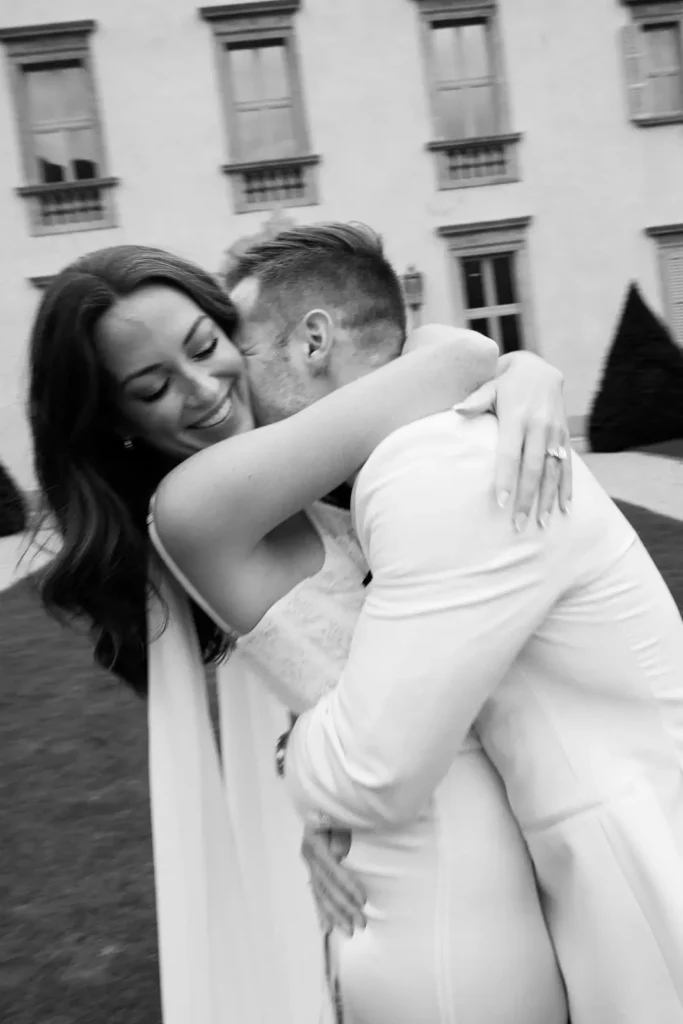 Bride and groom hugging outside Villa Balbiano, black and white portrait