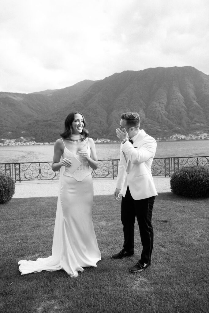 Bride and groom laughing on the lawn at Villa Balbiano with Lake Como views after emotional vows