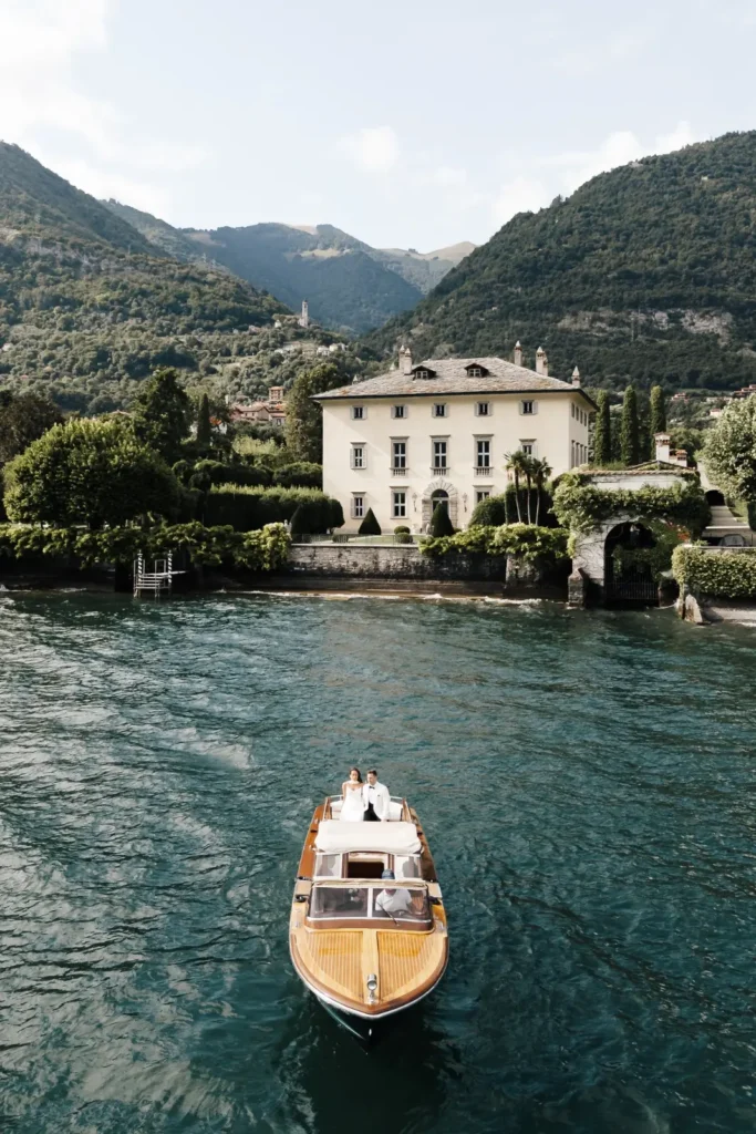 Boat arriving at Villa Balbiano on Lake Como, aerial view + drone shot